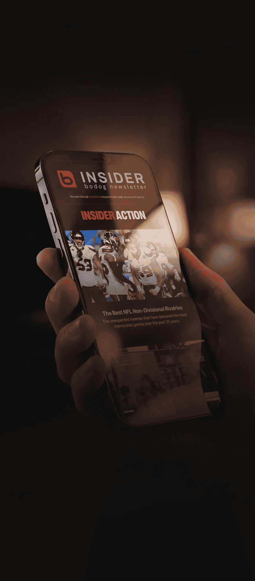User holding phone and viewing Bodog newsletter