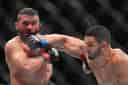 Aaron Pico, right, of the United States, hits Patricio Pitbull, left, of Brazil, in a featherweight bout at the UFC 327