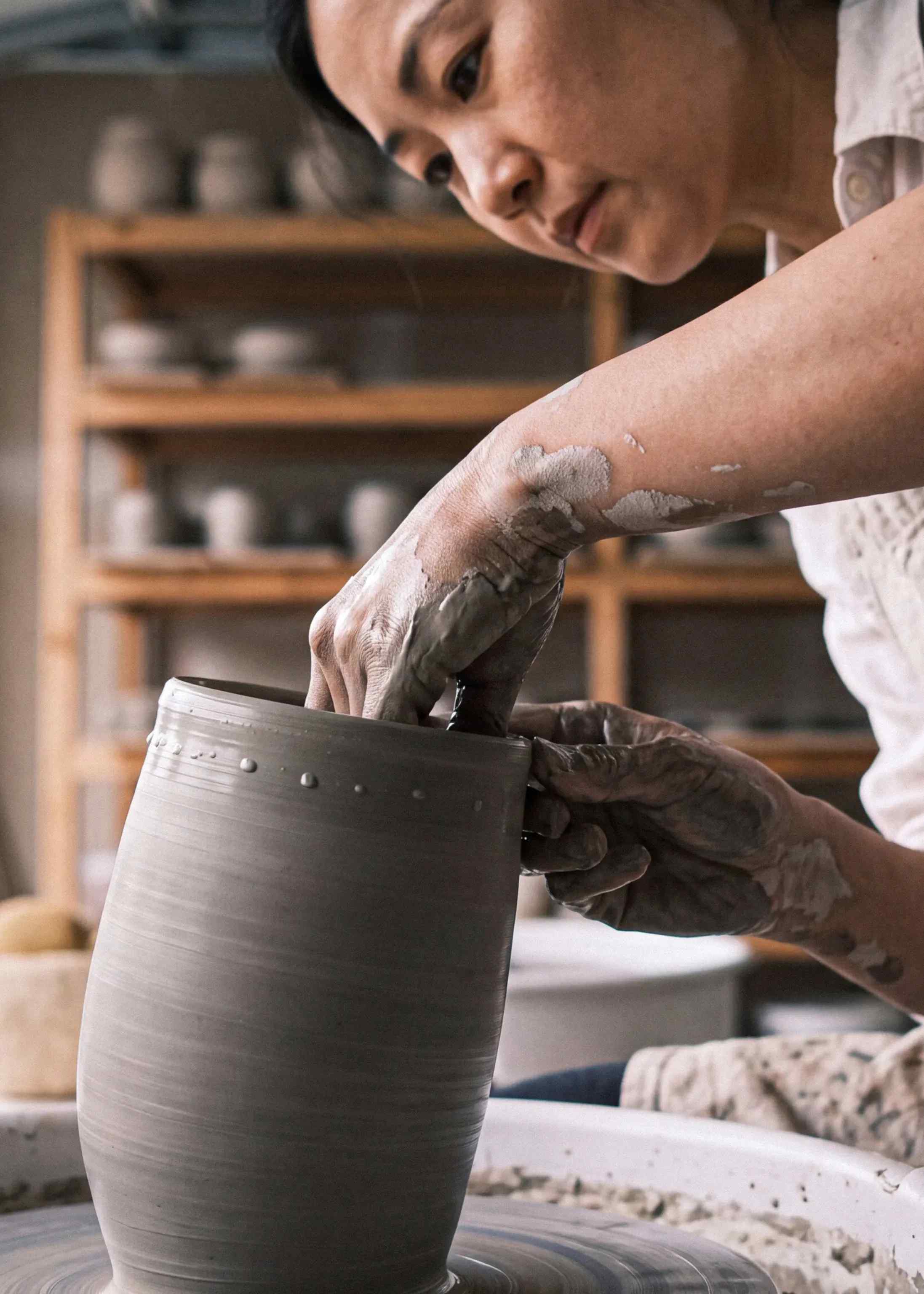 A woman sculpting clay