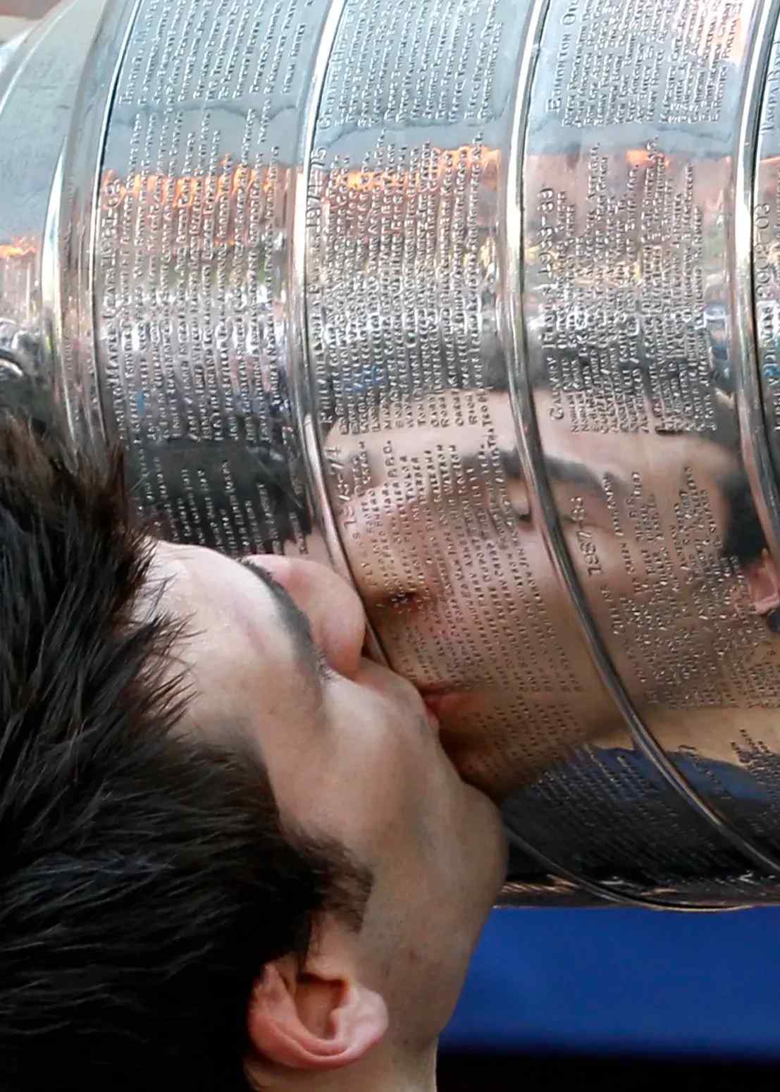 Patrice Bergeron kissing the Stanley Cup.