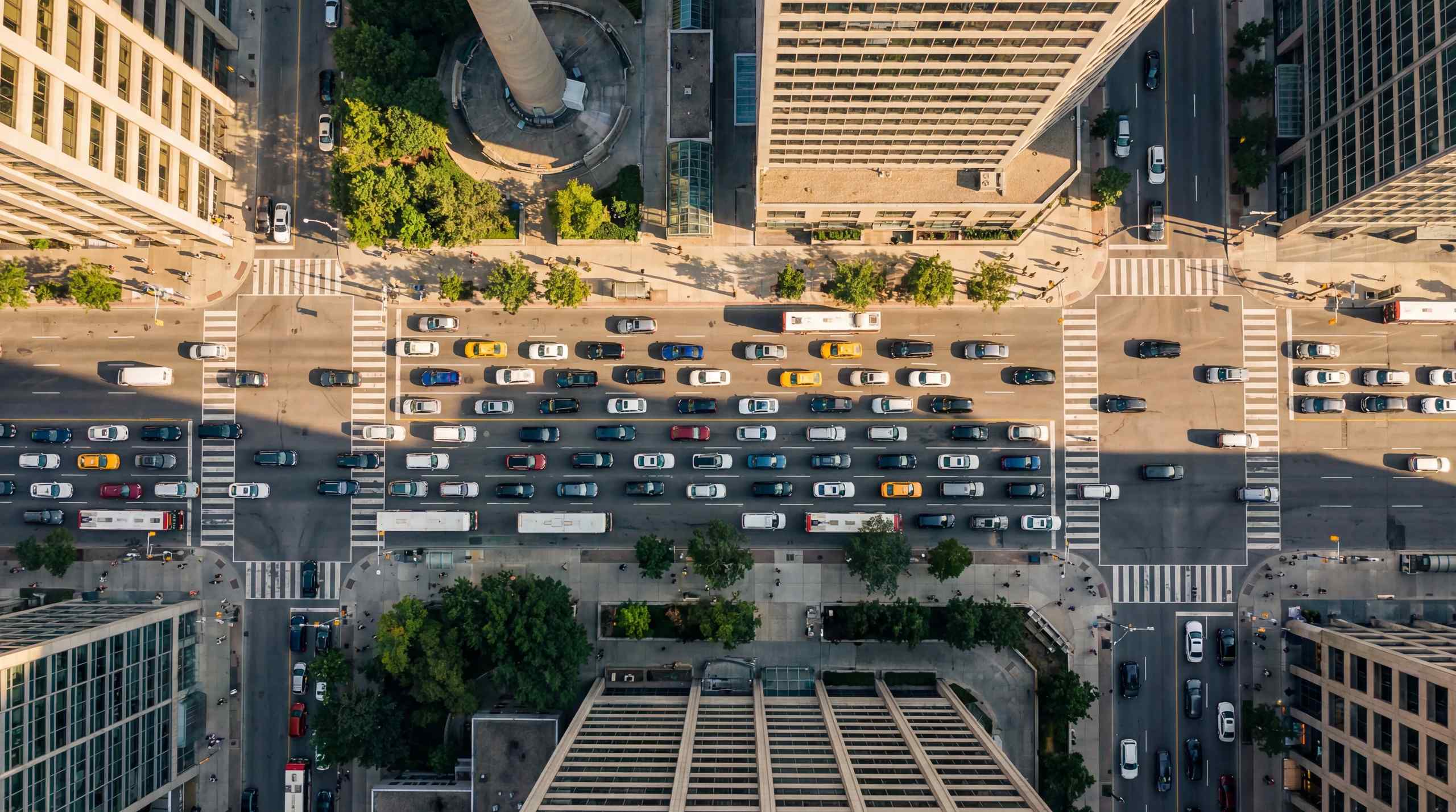 A large number of cars on the road in a city.