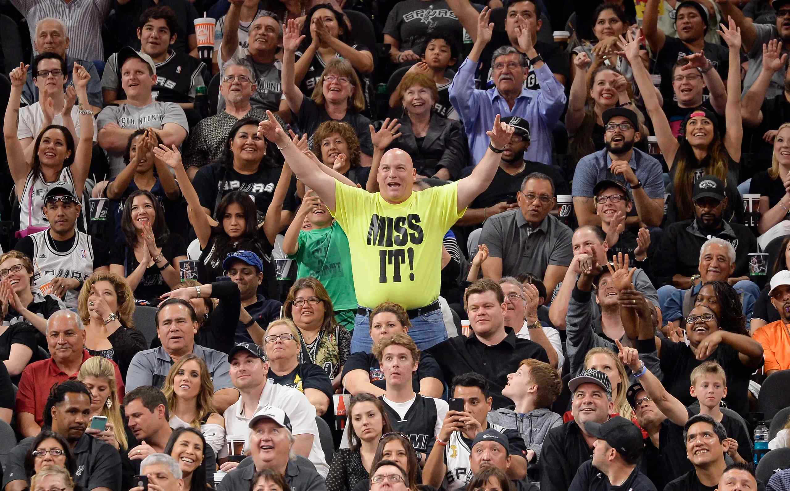 An passionate fan wearing a "miss it" t-shirt.