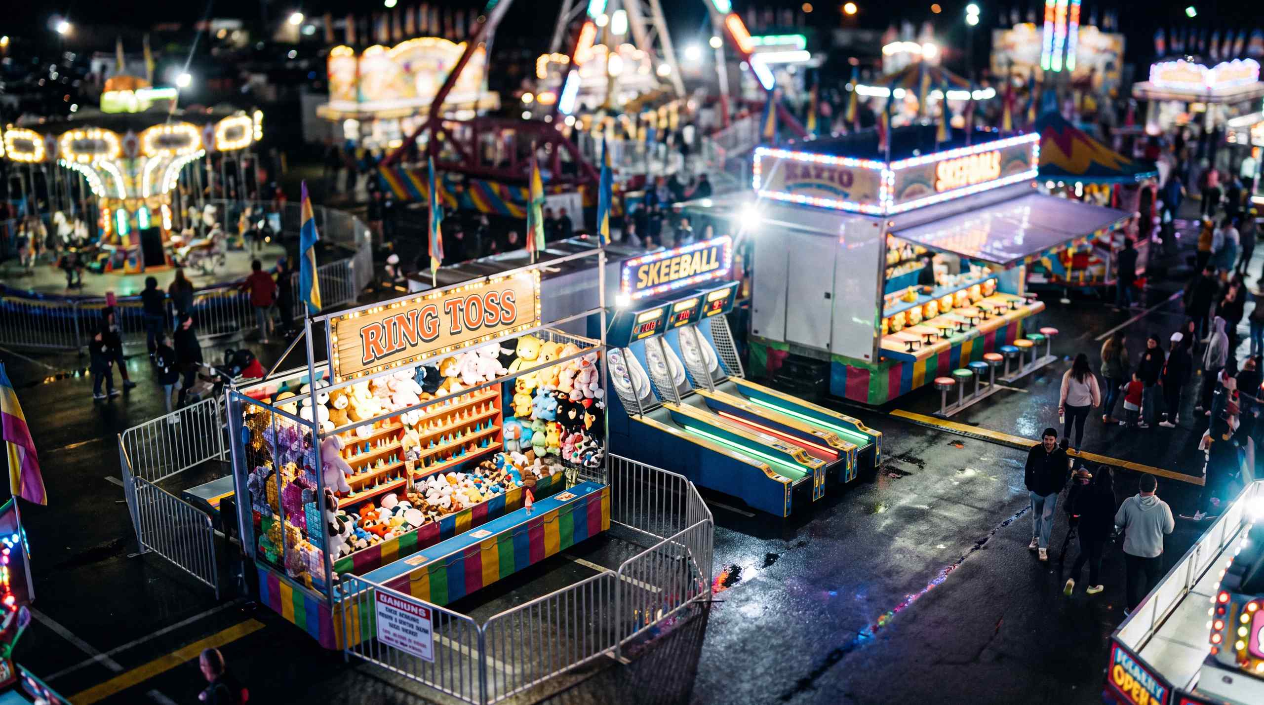 A selection of carnival games including skeeball and ring toss.