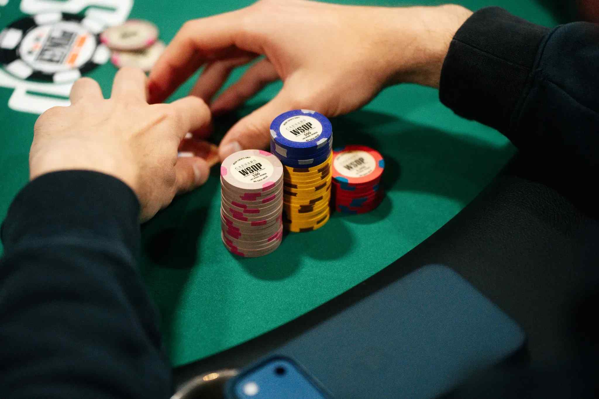 Hands in front of poker chips and cards 