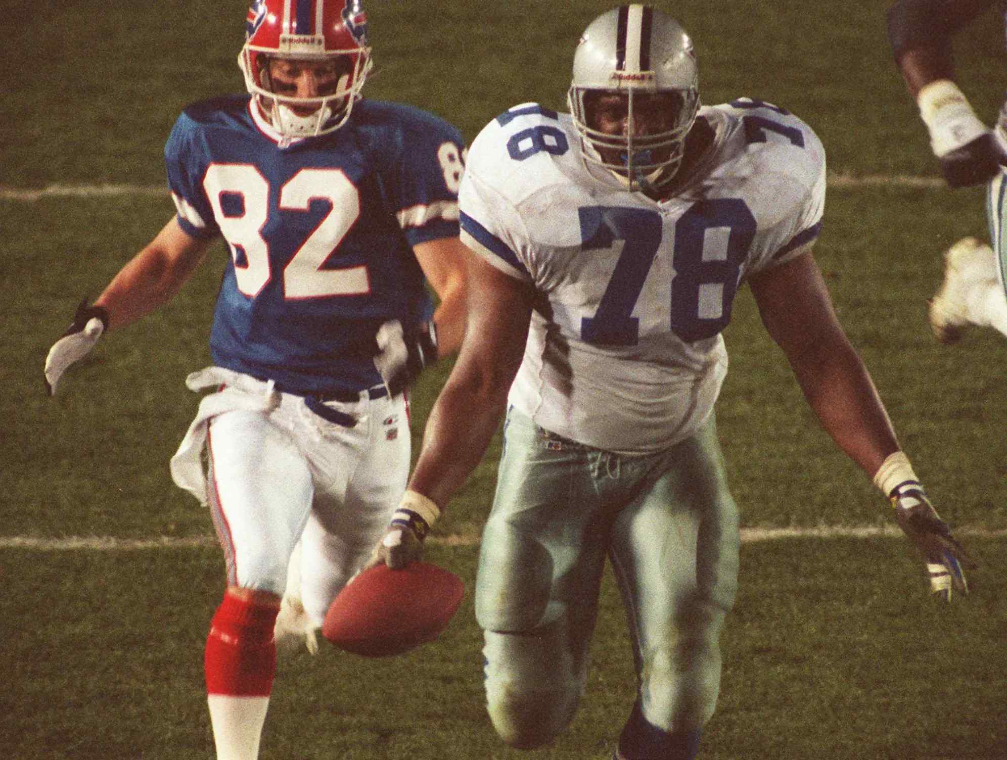 Dallas Cowboys defensive tackle Leon Lett slows down to celebrate a touchdown as Buffalo Bills wide receiver Don Beebe behind.