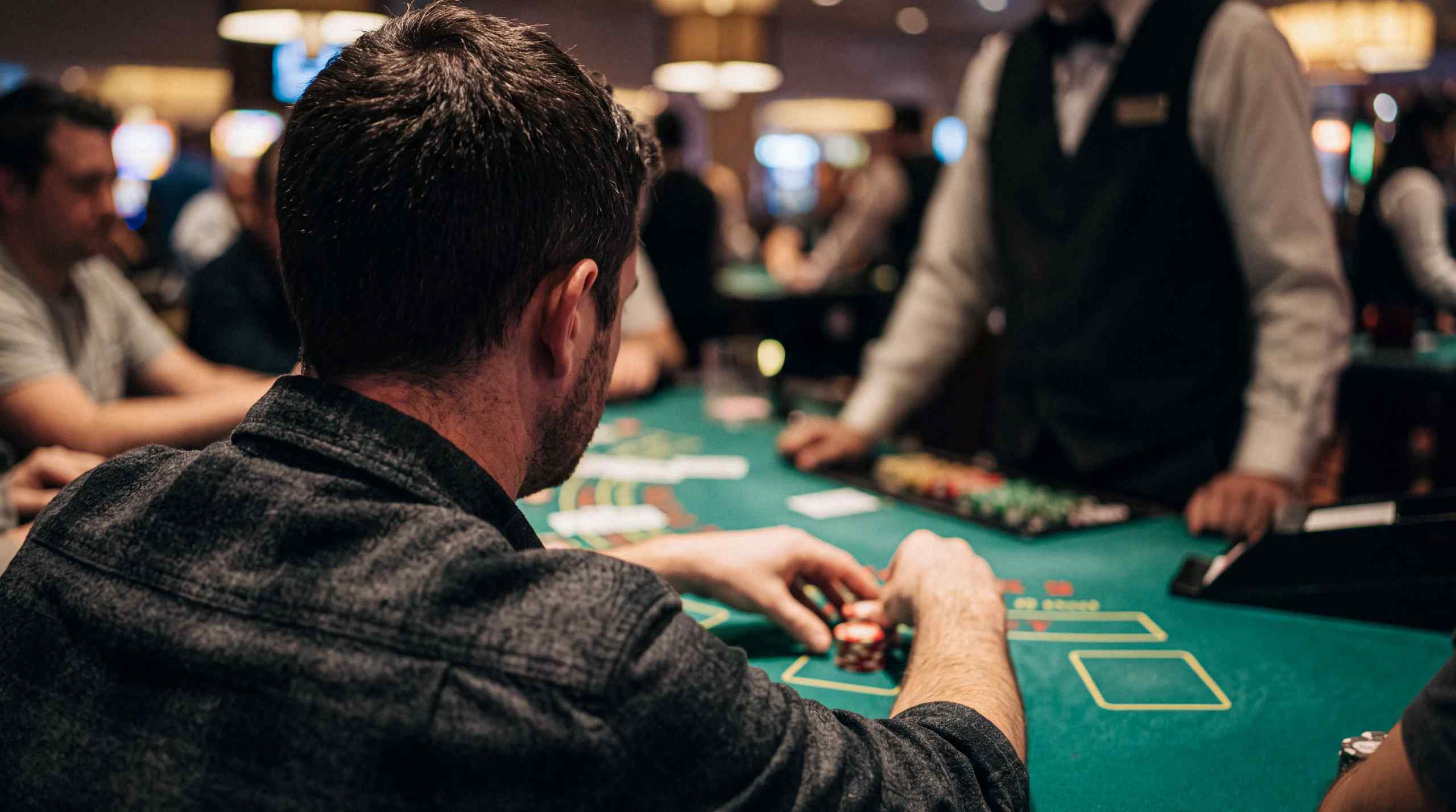 man sitting at gambling table