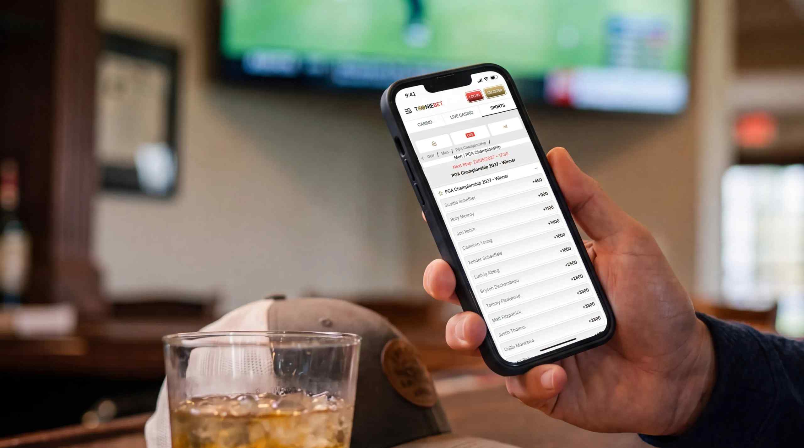 Man in golf club after a round looking to place his bets. 