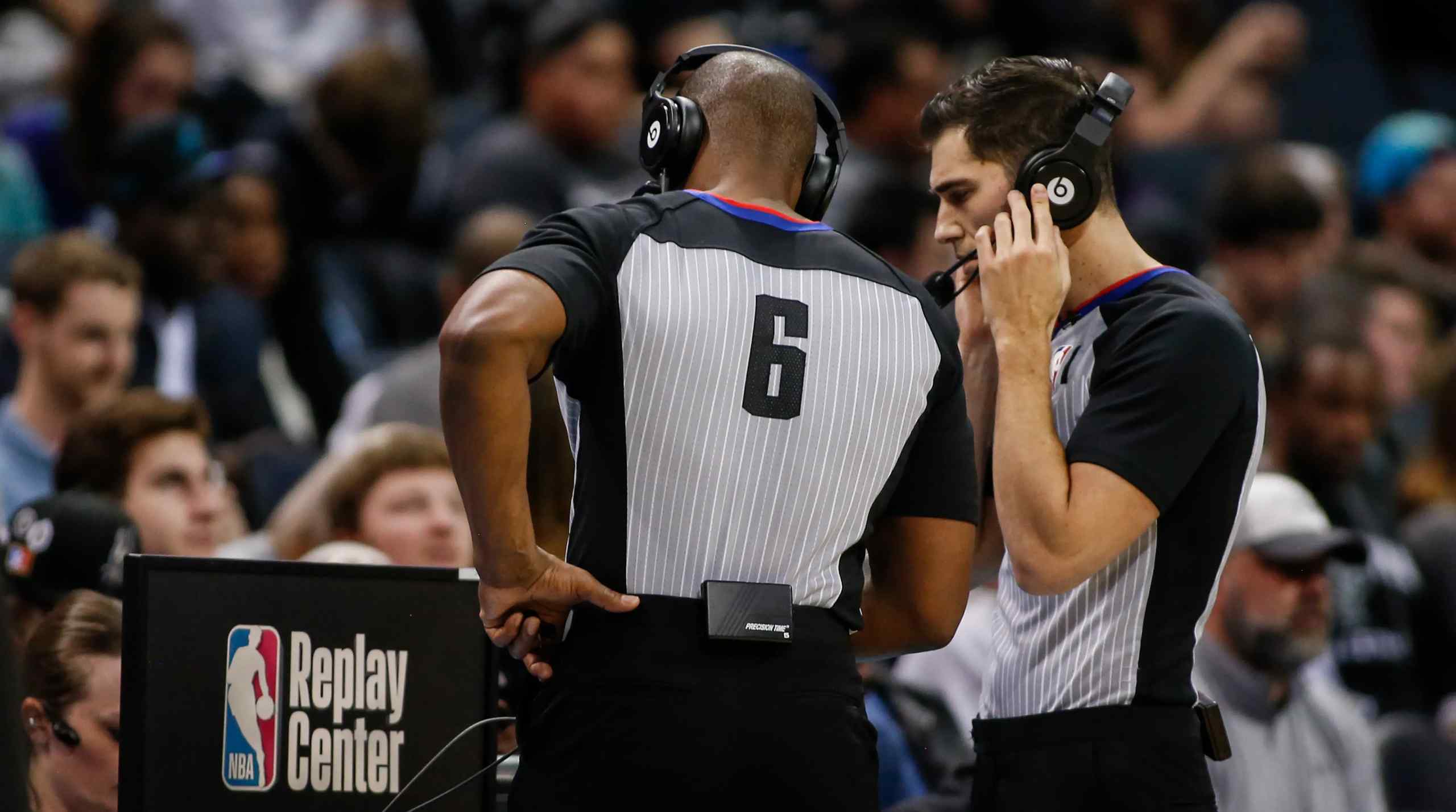 NBA refs discussing a play