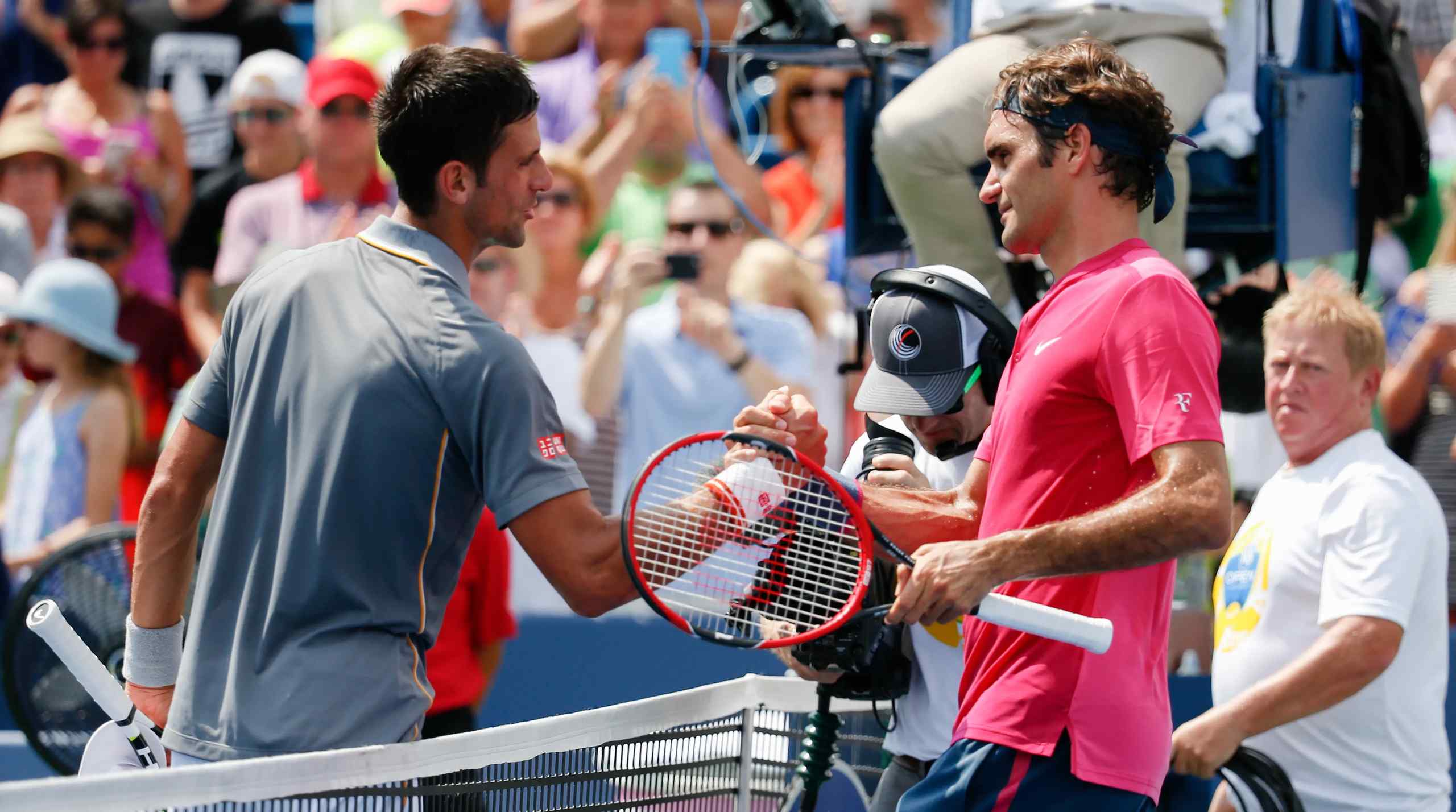 Novak Djokovic shaking hands with Roger Federer