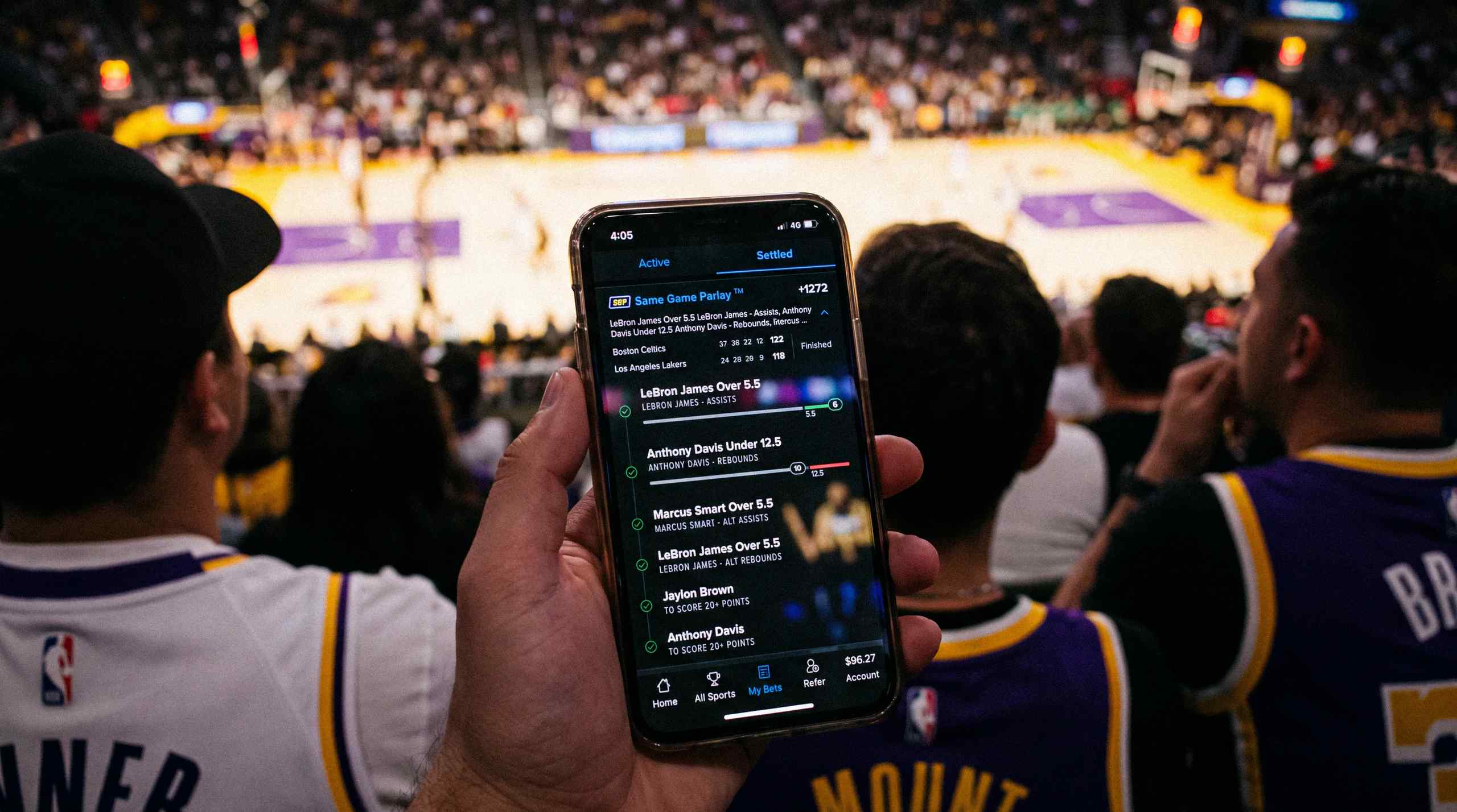 A man looking at a same-game parlay on his mobile device