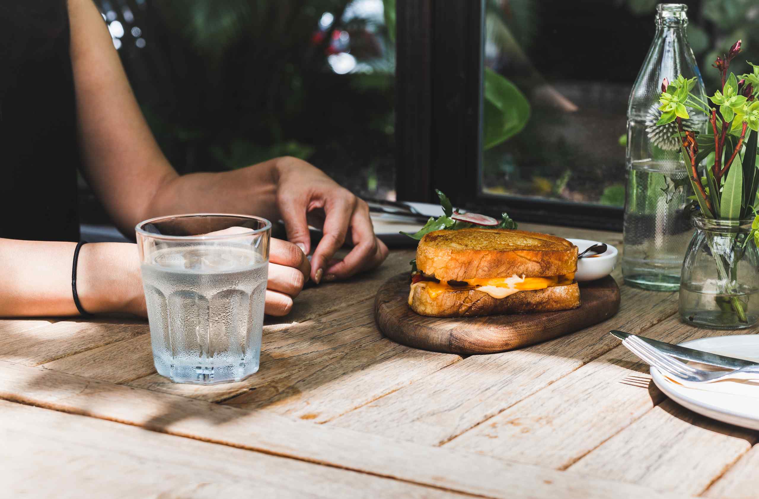A greasy sandwich on a table.