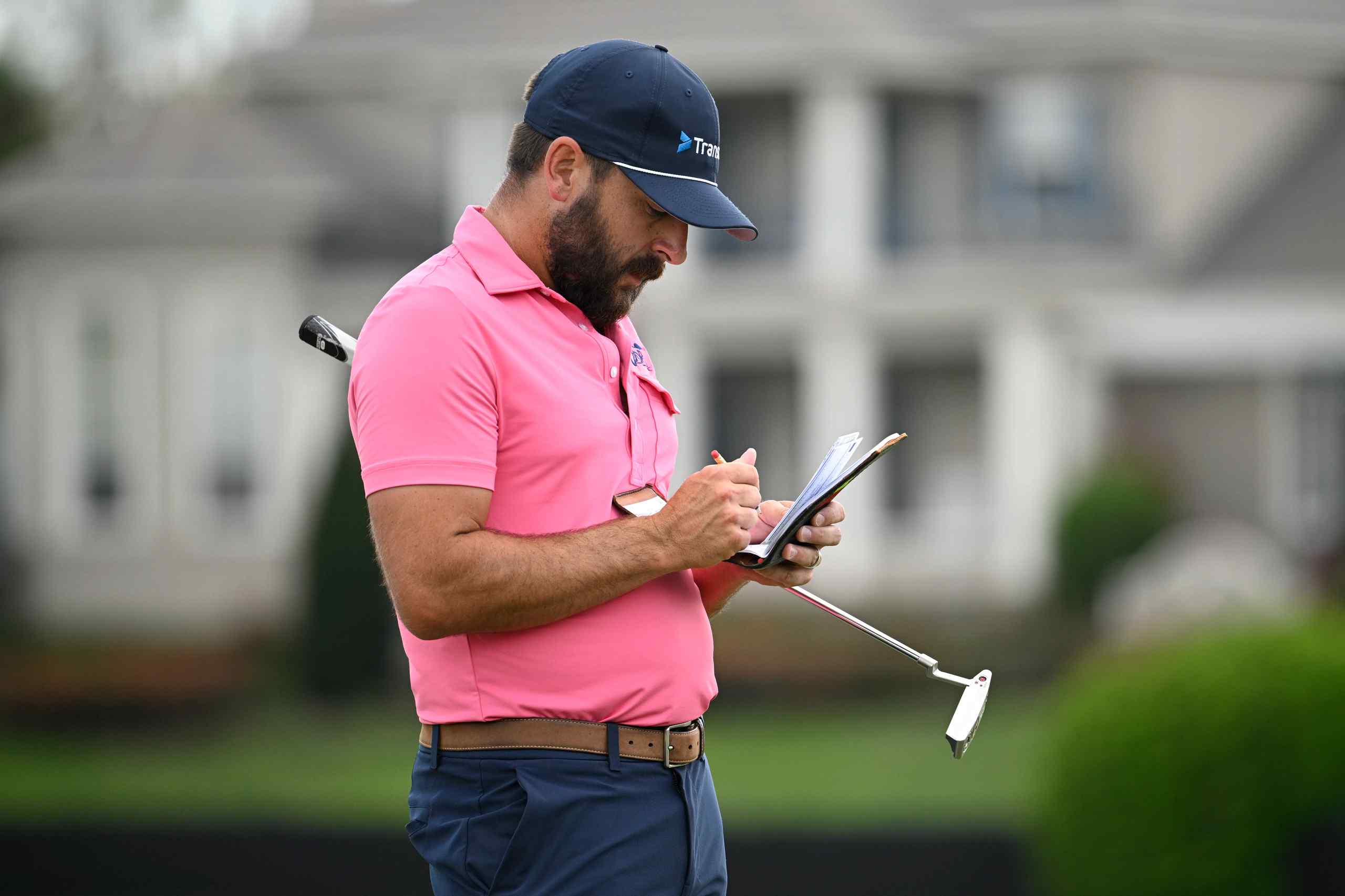 Professional golfer Stephan Jäger filling out his scorecard during a tournament round.
