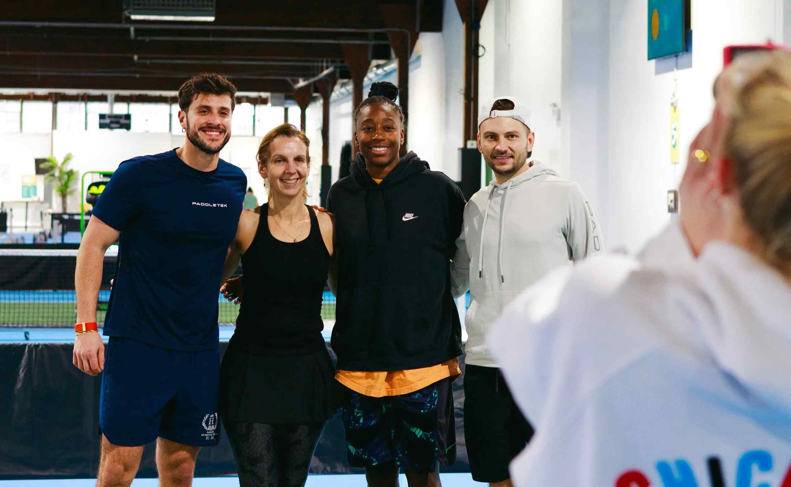 Emir Hamzic (left) with students and friends at a pickleball facility.