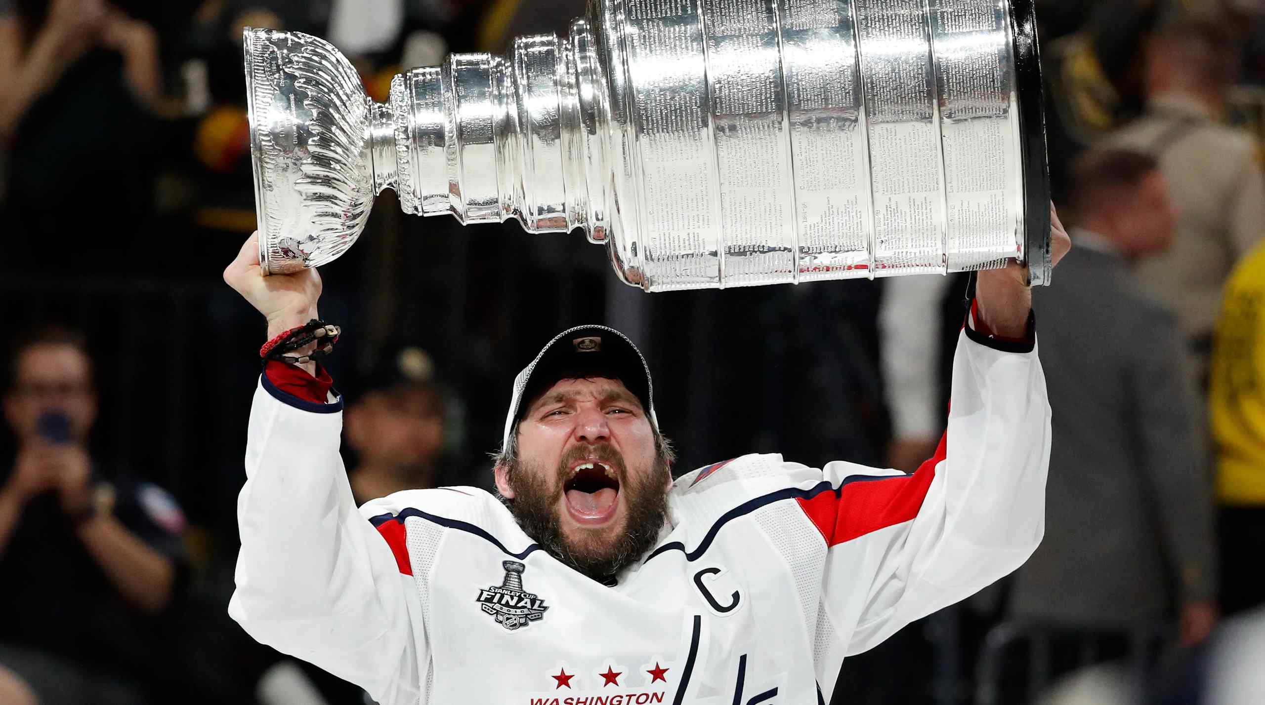 Alexander Ovechkin raising the Stanley Cup.