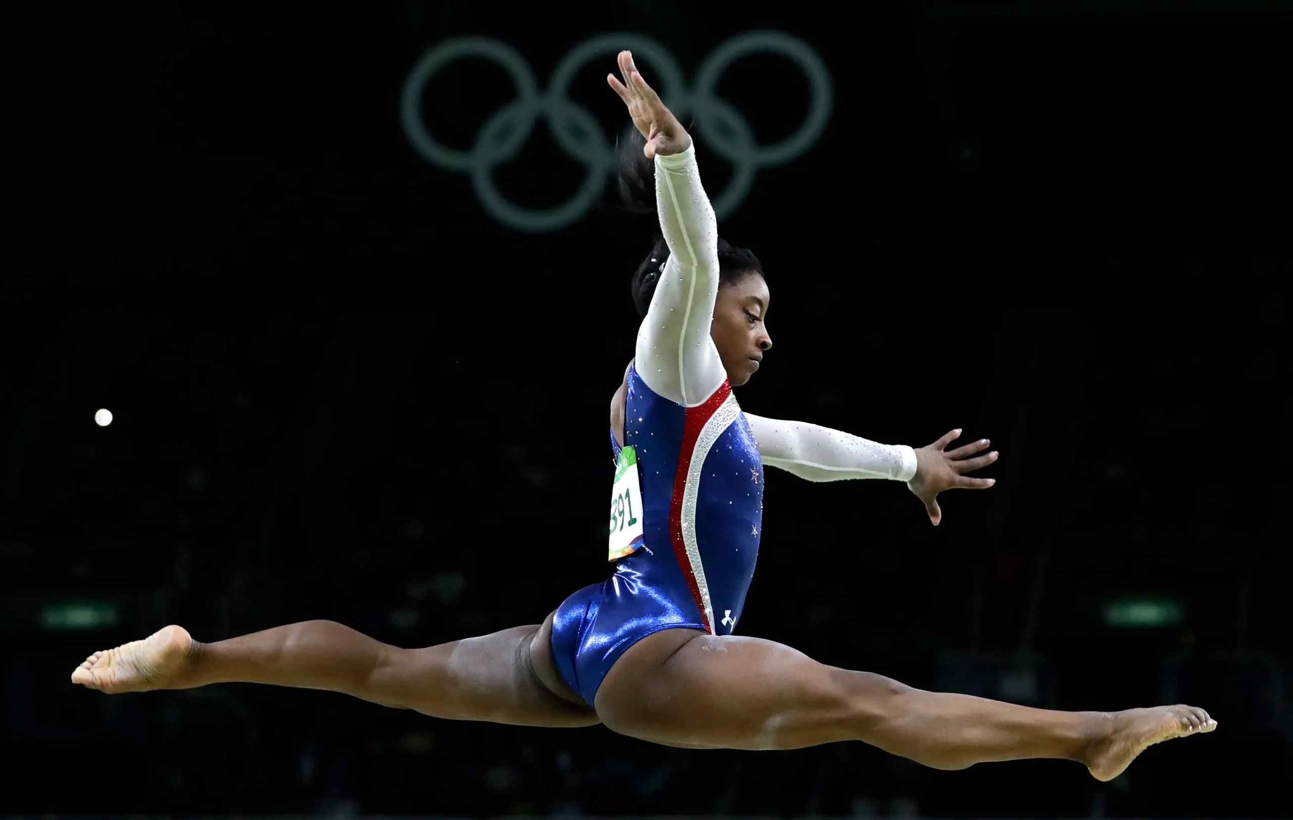 Simone Biles mid jump.