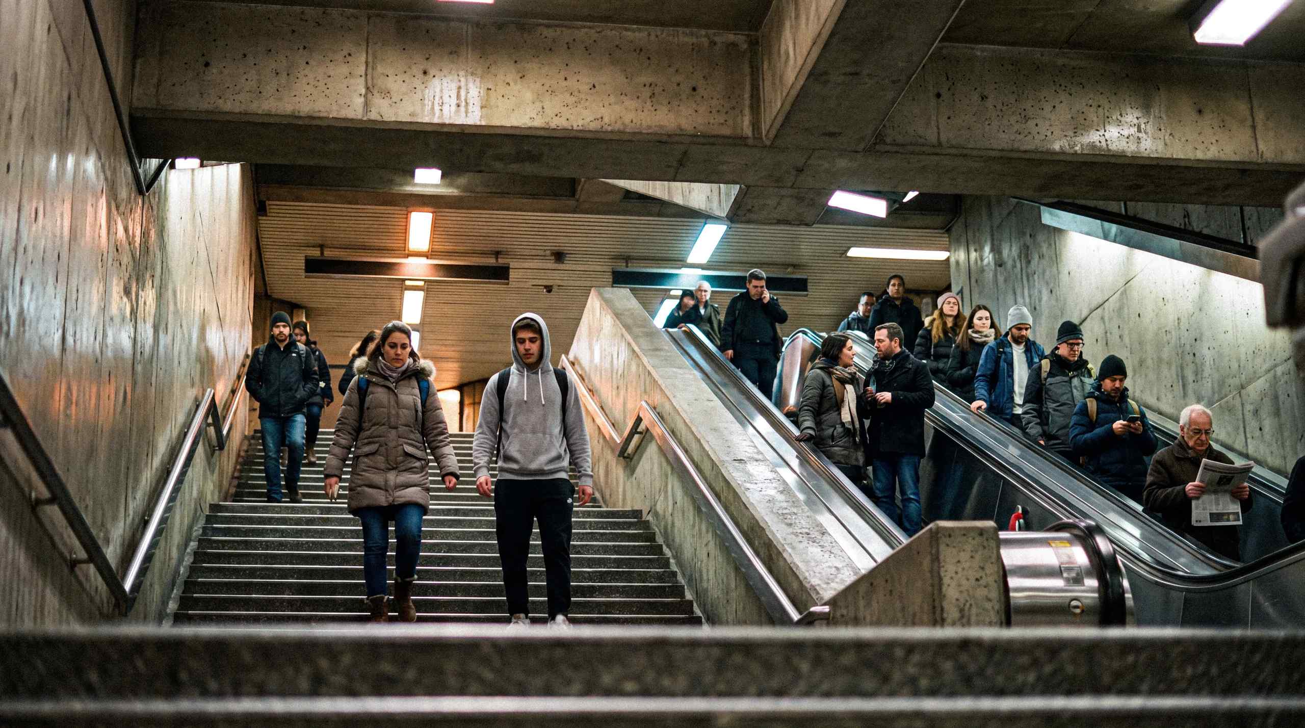 A group of people using the stairs instead of escalators