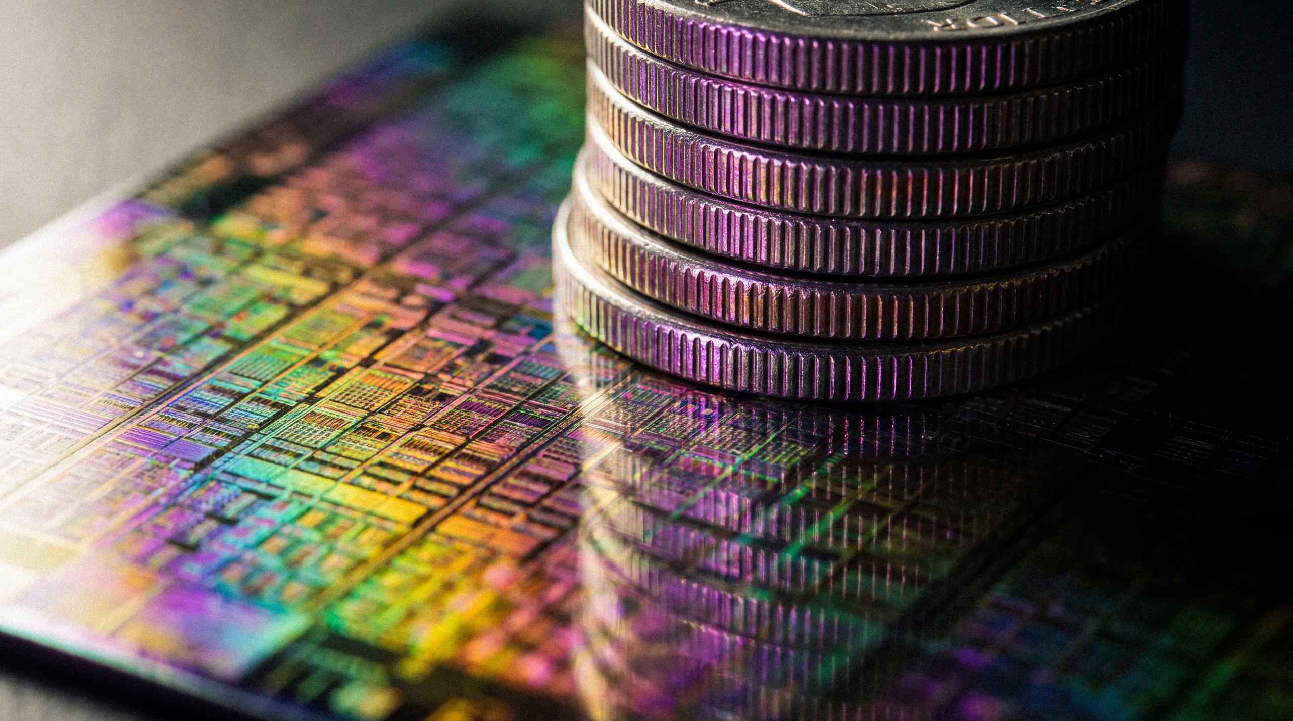 A stylized GPU chipset with coins on top of it.