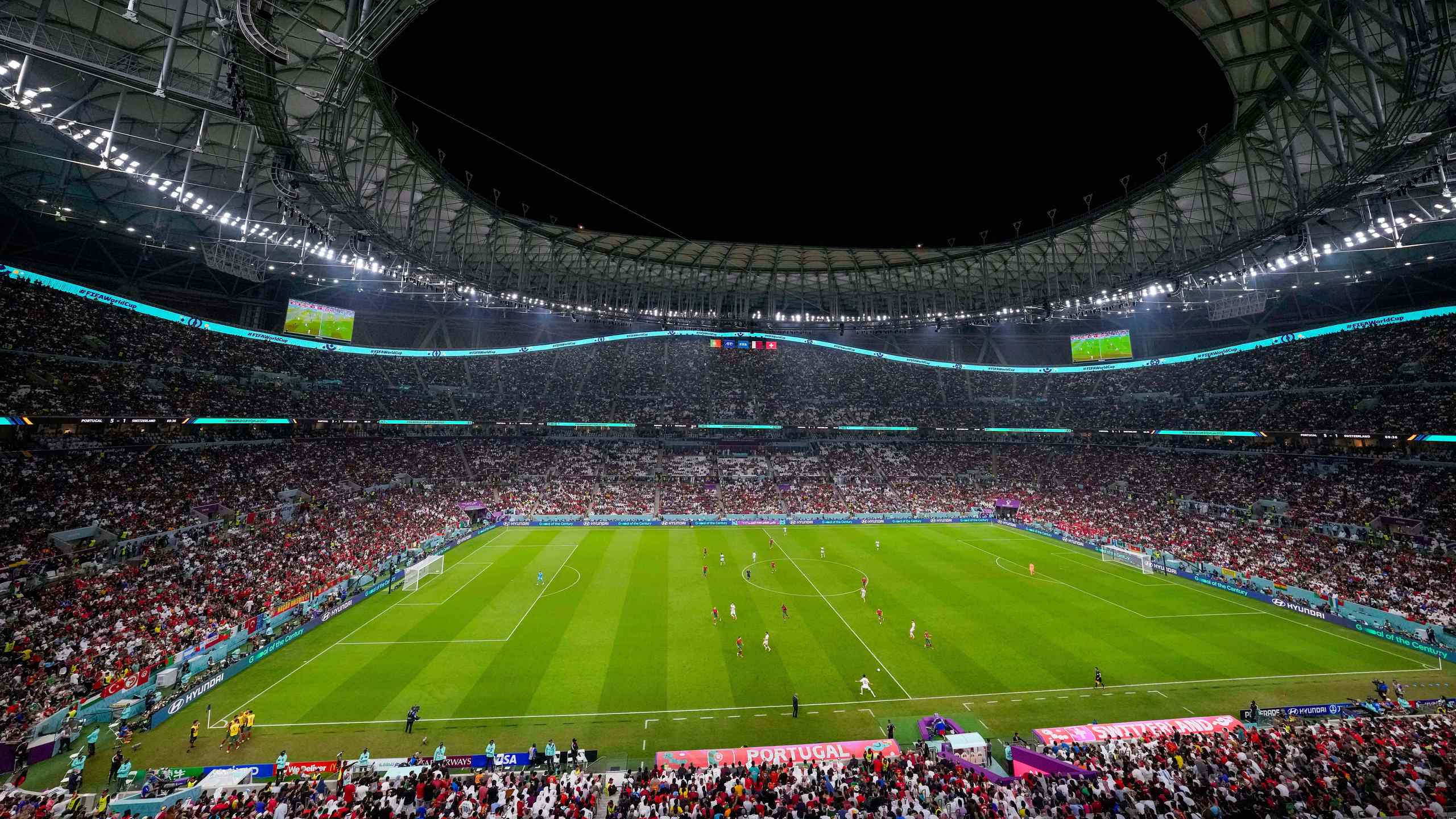 A stadium with a soccer match taking place.
