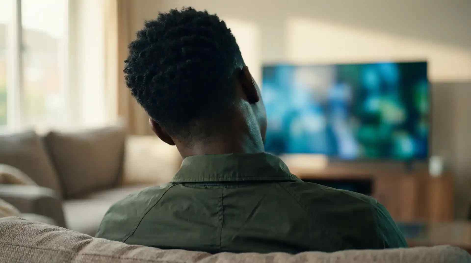 Man looking at television