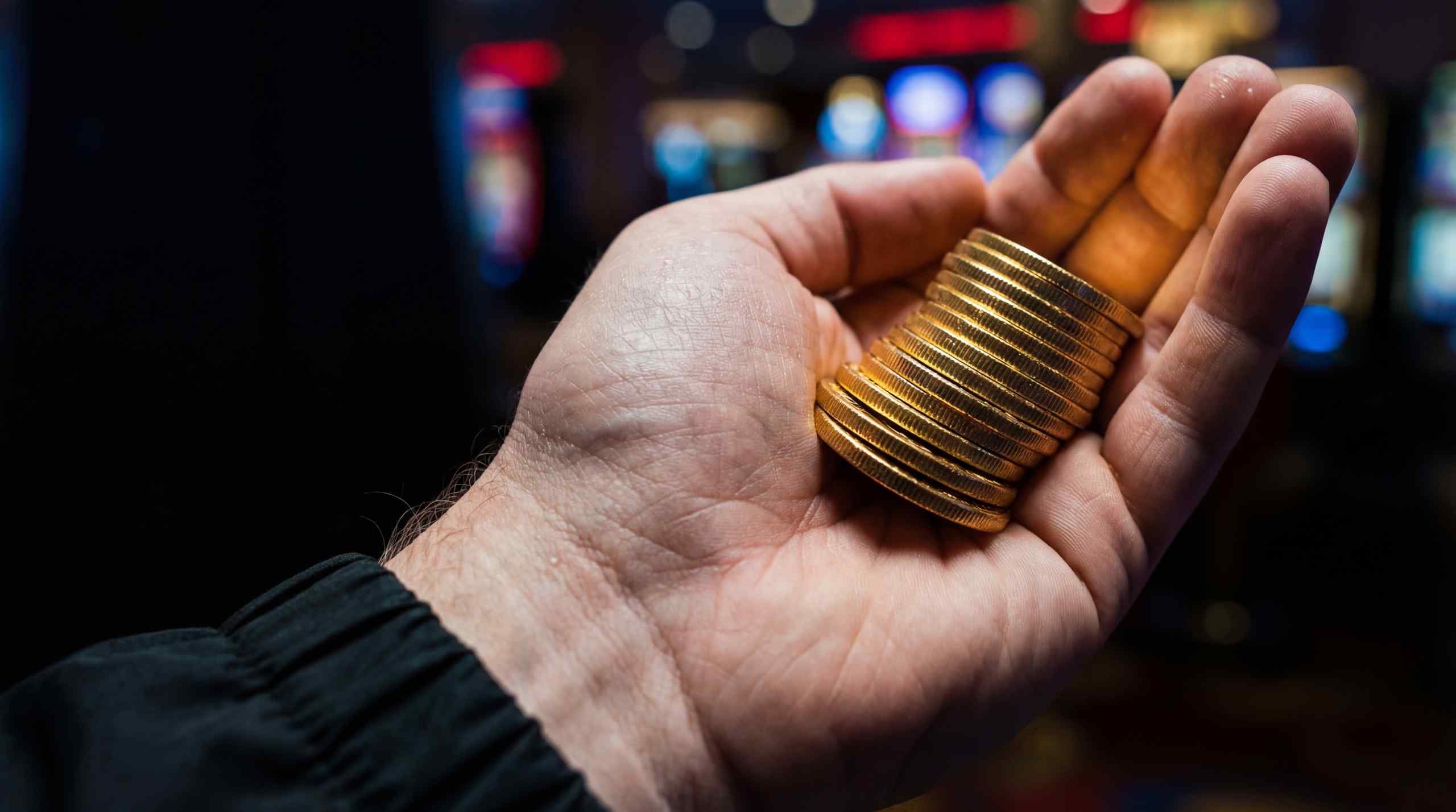 A hand holding coins relevant to sweepstakes bonuses