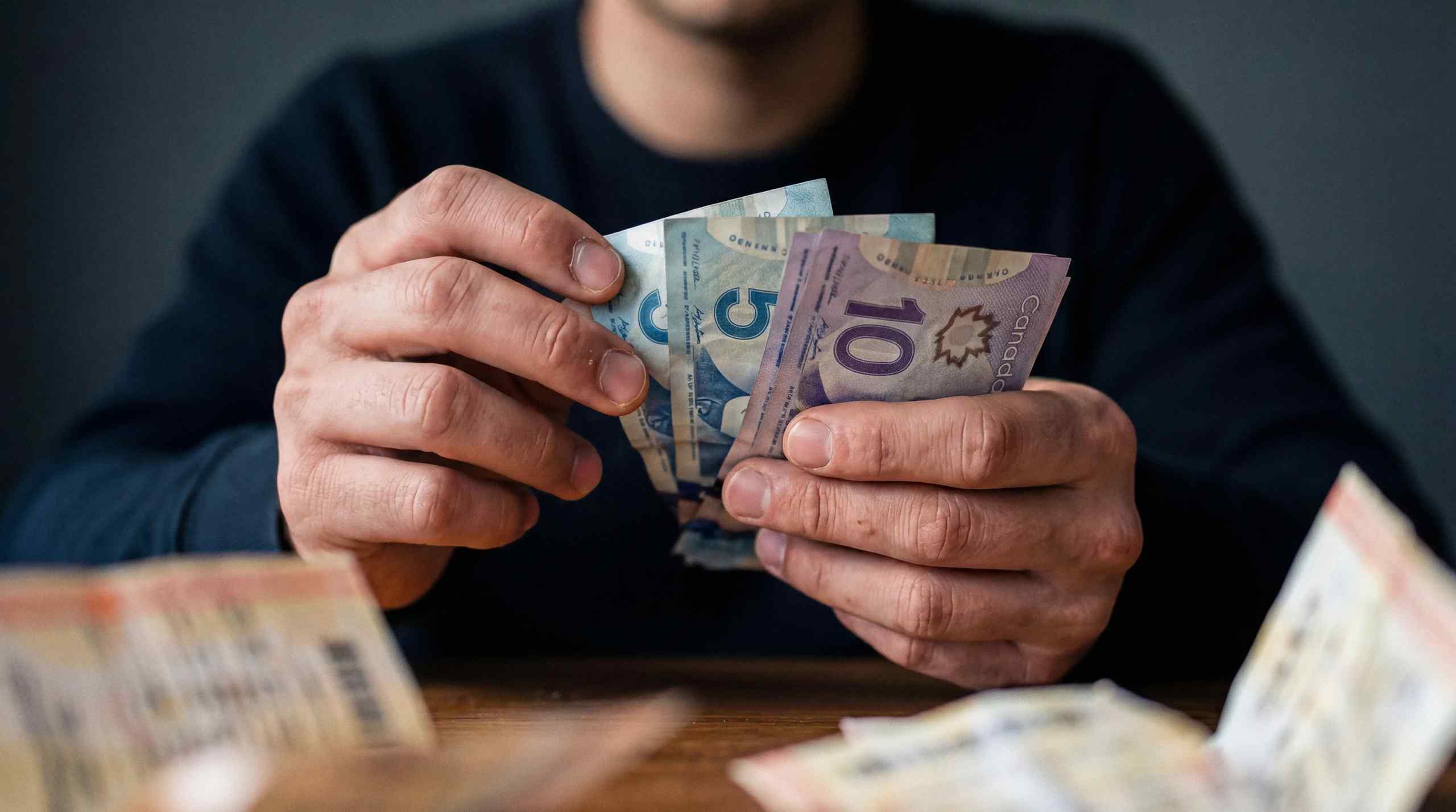 A person counting their cash.